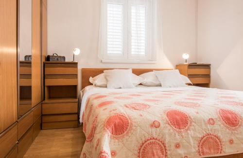 a bedroom with a bed and a window at Apartments Mate in Tučepi