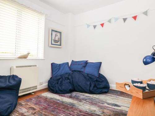 a bedroom with a bean bag bed and a window at Bolenowe in Polzeath
