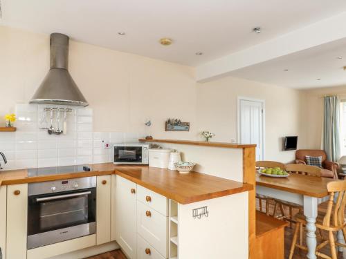 a kitchen with white cabinets and a counter top at Bolenowe in Polzeath
