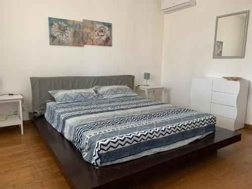 a bedroom with a bed with a blanket on it at Villa Gabry e Villa Fiorita in Camaiore