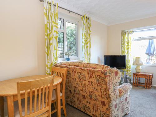 a living room with a couch and a table at Robyn's Nest in Sharrington
