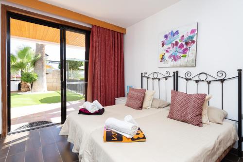 a bedroom with two beds and a large window at ViVa Royal - Immense villa, unique and exclusive in Chayofa