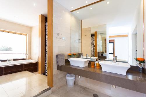 a bathroom with two sinks and a large mirror at ViVaTenerife - Immense villa, unique and exclusive in Chayofa