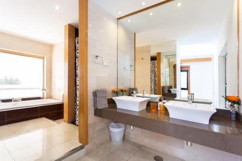 a bathroom with two sinks and a large mirror at ViVa Royal - Immense villa, unique and exclusive in Chayofa