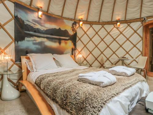 a bed in a yurt with two pillows on it at Island Yurt in Beckford