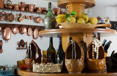 a shelf with bottles of wine and shoes on it at Hotel & Spa Bellavista Francischiello in Massa Lubrense