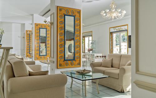 a living room with two chairs and a table at Hotel & Spa Bellavista Francischiello in Massa Lubrense