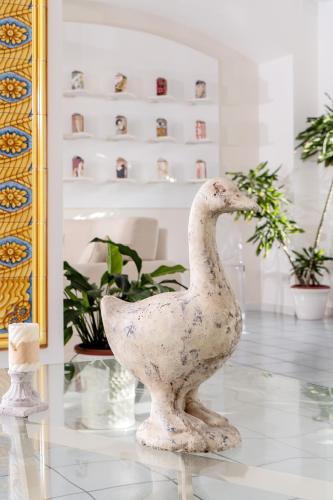 a statue of a duck sitting on a table at Hotel & Spa Bellavista Francischiello in Massa Lubrense