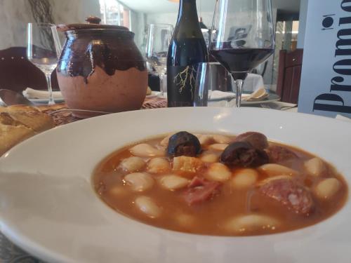 a plate of food on a table with a bowl of food at Segovia Sierra de Guadarrama in Los Ángeles de San Rafael