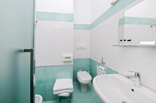 a bathroom with a white sink and a toilet at Hotel & Spa Bellavista Francischiello in Massa Lubrense