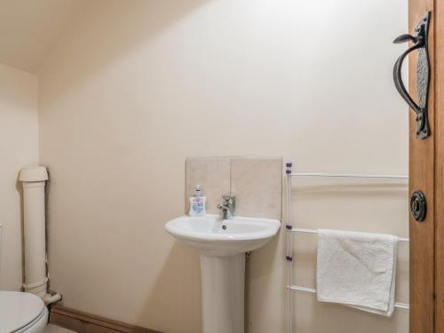 a bathroom with a sink and a toilet and a shower at Glebe Barn in Caynham
