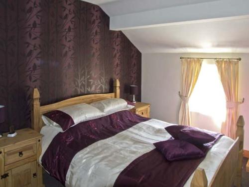 a bedroom with a large bed and a window at New Cottage Farm in Flash