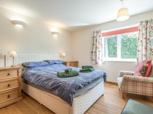 a bedroom with a bed with two teddy bears on it at The Schoolhouse Bakehouse in Bishops Castle