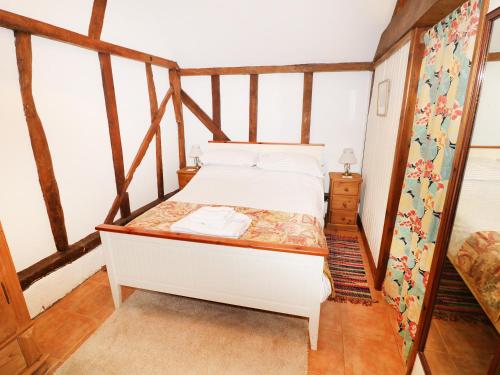 a small bedroom with a bed in a attic at The Pottery in Urchfont