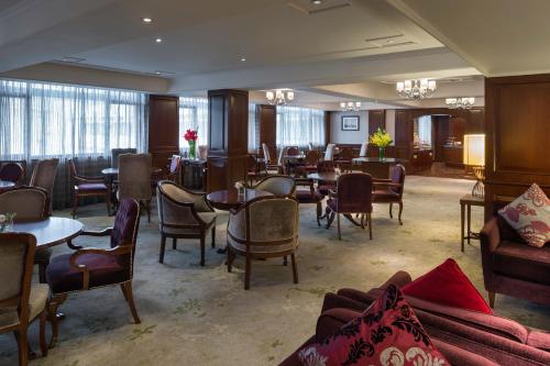a living room filled with lots of furniture at Marco Polo Hongkong Hotel in Hong Kong