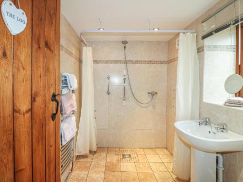a bathroom with a shower and a sink at Fletchers Barn in Alderwasley