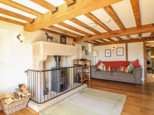 a living room with a fireplace and a couch at The Milk House in Wirksworth