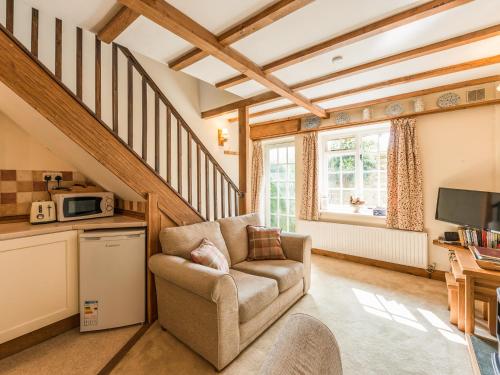 a living room with a chair and a microwave at Old Town Cottage in Ludlow