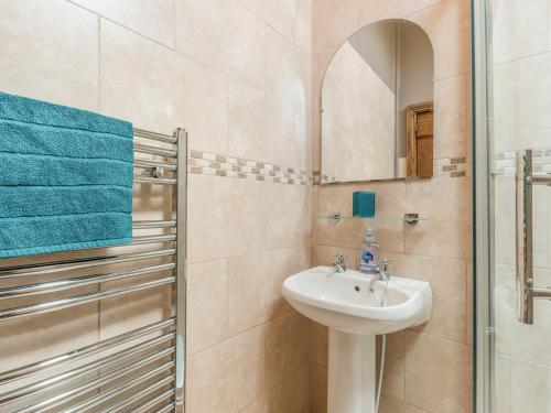 a bathroom with a sink and a mirror at Old Town Cottage in Ludlow