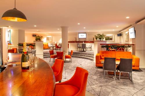 a room with a table and chairs and a bar at Copthorne Aberdeen Hotel in Aberdeen