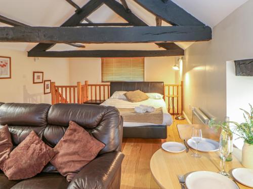 a living room with a couch and a bed at The Annex - Eden House in Edenhall