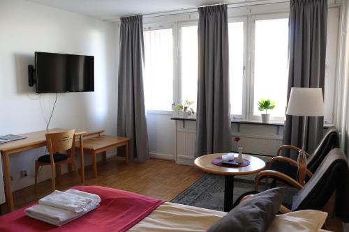 a living room with a couch and a table at RS Lägenhetshotell Skövde in Skövde