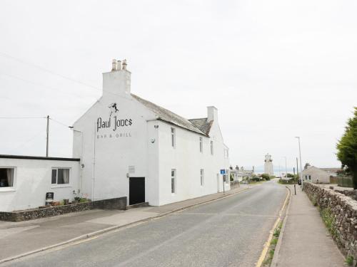 a white building on the side of a street at Simmer Dim in Kirkbean