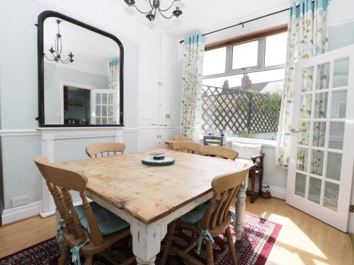 a dining room with a wooden table and chairs at Number Fifteen in Withernsea