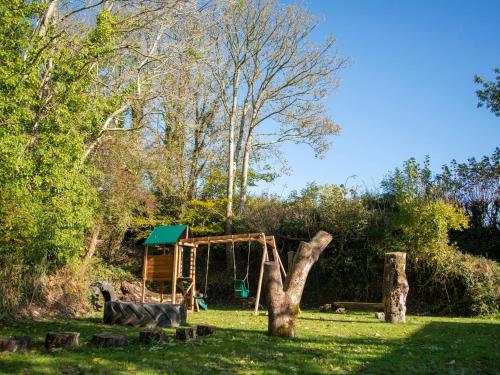 a playground in a park with a swing at Llaethdy - The Dairy in Newchapel