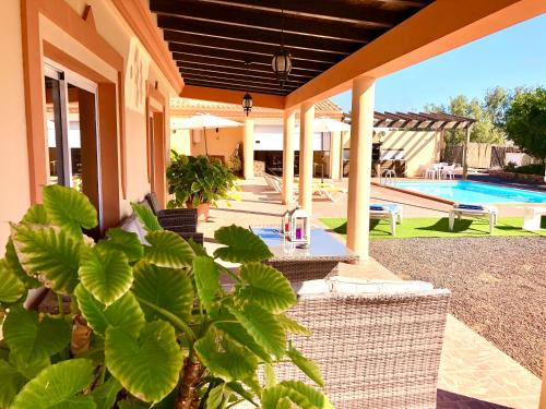 a house with a patio and a swimming pool at Villa Oliva Fuerteventura in Tuineje