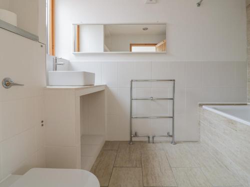 a bathroom with a sink and a toilet and a mirror at Frater House in Alburgh