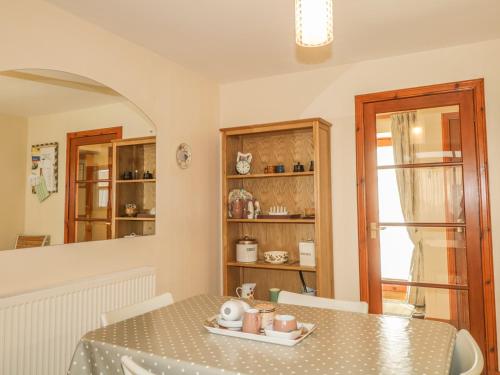 a dining room with a table and chairs and a window at The Farm Steading in Aberlour