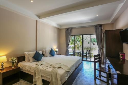 A bed or beds in a room at Naiharn Beach Resort - SHA Plus Extra