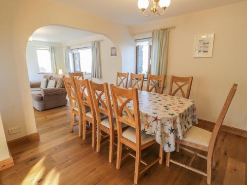a dining room with a table and chairs at Awel Y Llan in Llanfair