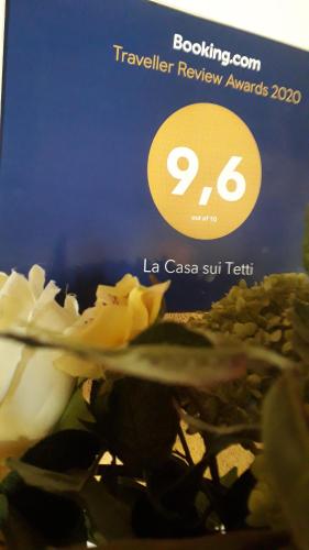 a book with a picture of a flower on it at La Casa sui Tetti in Novi Ligure