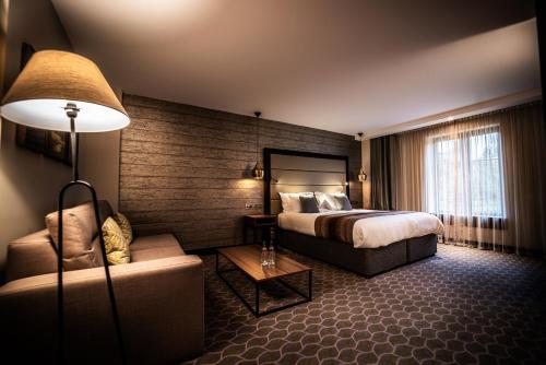 pokój hotelowy z łóżkiem i kanapą w obiekcie The Warwickshire Hotel and Country Club w mieście Warwick