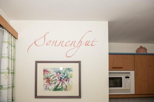a kitchen with a sign that reads contempt on a wall at Appartement-Pension Fahrnberggut in Rauris