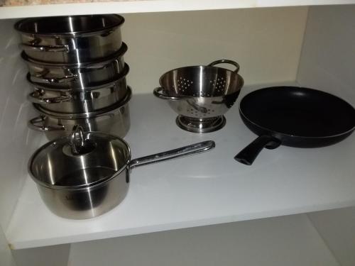 a counter with pots and pans on a shelf at Sarah's Place Guesthouse in Pretoria