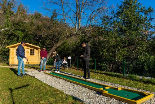 a group of people playing a game of trampoline at Villa AltaVista - Seaview & Relax with Heated Pool & MiniGolf in Opatija