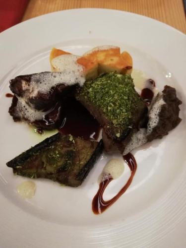 a white plate of food on a table at Der Löwen, Löwen Betriebs- und Management GmbH in Bludenz