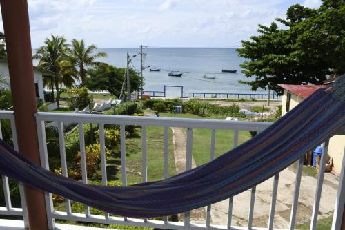 a hammock on a balcony overlooking the ocean at Posada Sweet Anashly in Providencia