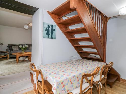 a dining room with a table and a staircase at The Coach House in Bristol