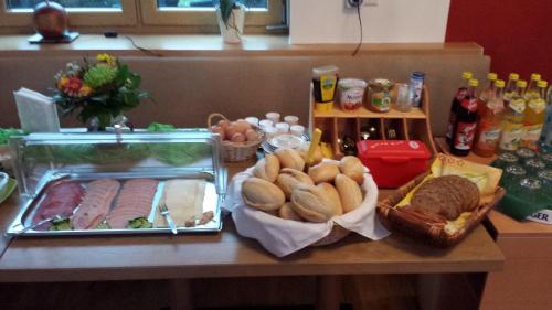 a table with bread and other foods on it at Gasthaus & Pension Am Rennsteig in Spechtsbrunn