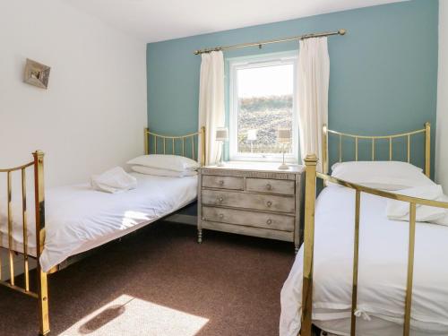 a bedroom with two bunk beds and a window at Sunset Cottage in Salen