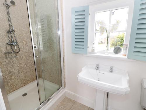 a bathroom with a sink and a shower at Croft View in Whitby