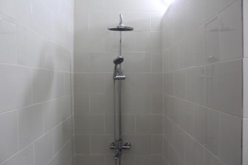a shower with a shower head in a bathroom at Park Hostel Osh in Osh