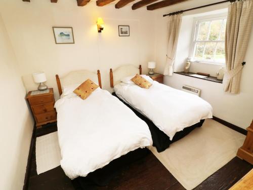 En eller flere senge i et værelse på Mill Cottage