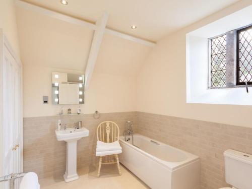 a bathroom with a bath tub and a sink and a bath tub at Great Bidlake Manor in Bridestowe