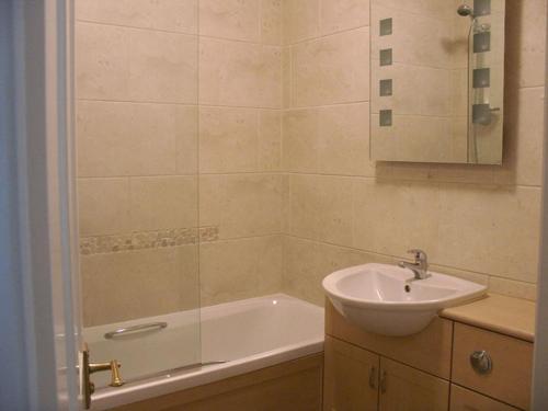 a bathroom with a sink and a bath tub at Glenview in Lynton