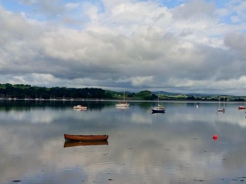 a group of boats sitting on a large body of water at 1 The Quay in Lympstone